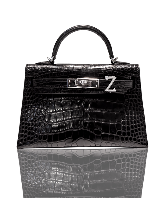 A black crocodile handbag with a 'Z' initial brooch attached to it, resembling a Birkin or Kelly bag, collection-preview.