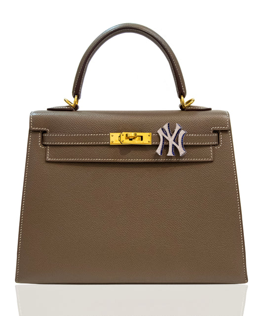 Brown handbag with a gold clasp and Yankees logo on a white background, collection-preview