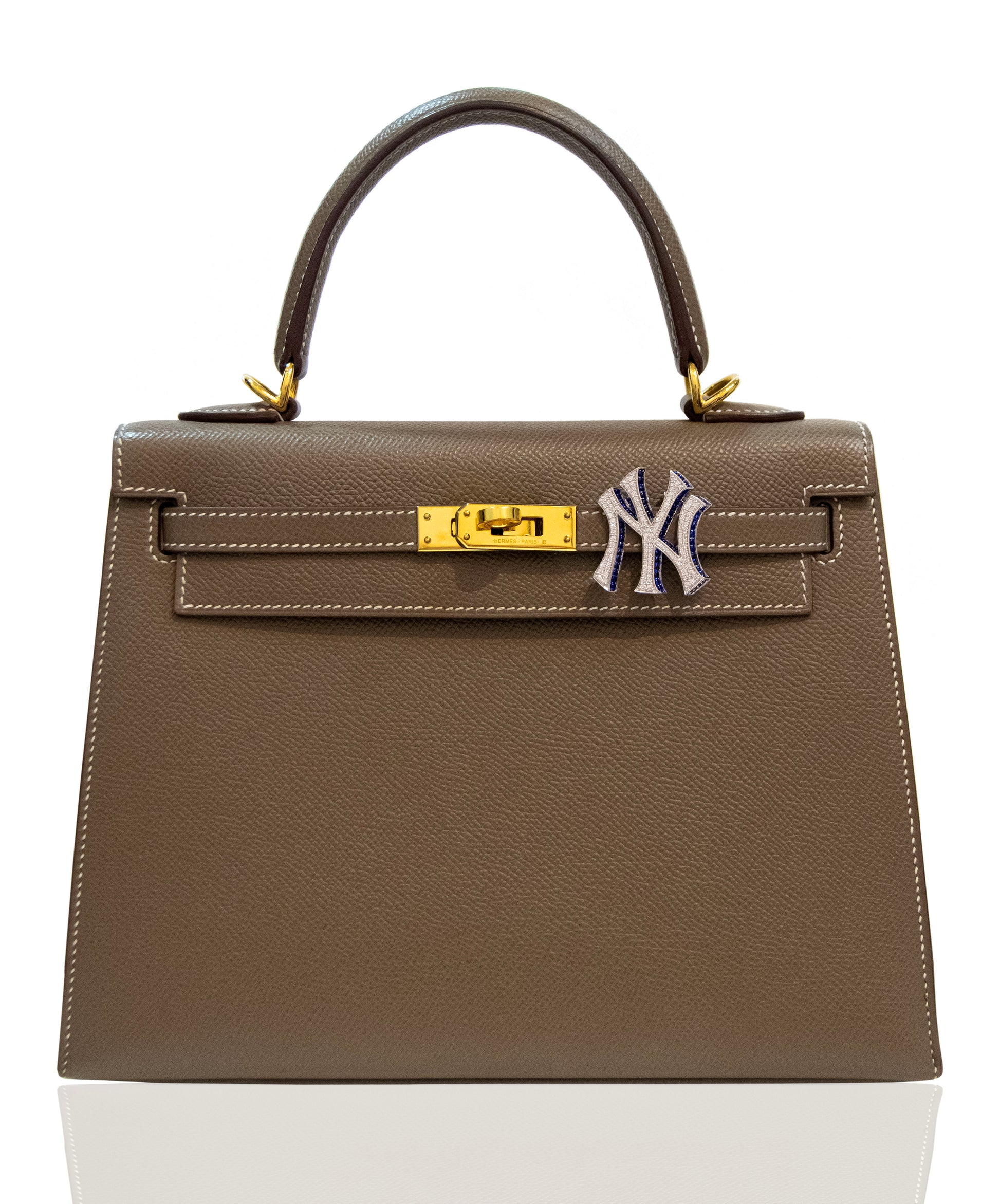 Brown handbag with a gold clasp and Yankees logo on a white background, collection-preview