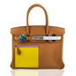 Brown handbag with a yellow patch and visible brand logo on a white , collection-previewbackground