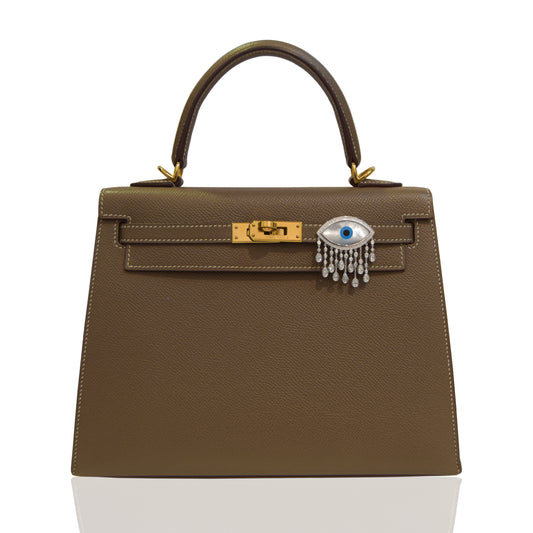 Brown handbag with a decorative clasp on a white background, collection-preview