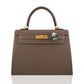 Brown handbag with a gold clasp and green brooch on a white background, collection-preview