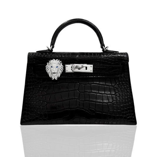 Black crocodile skin handbag with silver lion clasp on a white background, collection-preview
