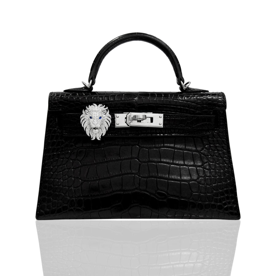 Black crocodile skin handbag with silver lion clasp on a white background, collection-preview