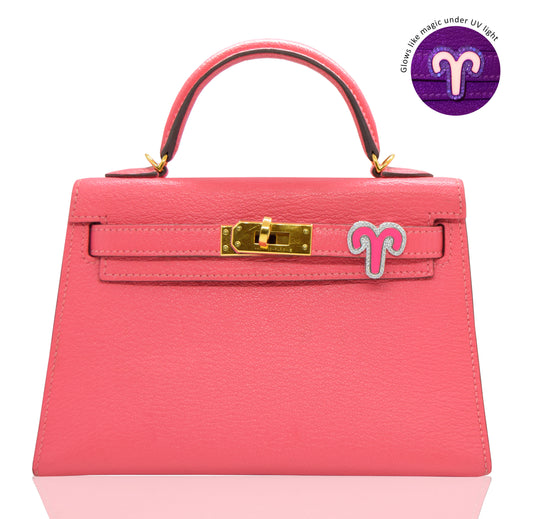 Pink handbag with gold hardware on a white background, collection-preview