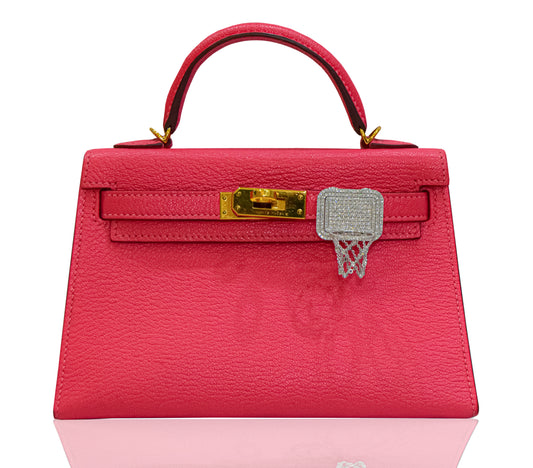 Pink handbag with gold clasp on a white background, collection-preview