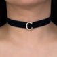 Navy blue velvet choker with a silver crescent moon pendant on a person's neck.