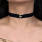 Black velvet choker with a gold 'F' pendant on a model wearing a gold top.