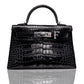 A black crocodile pattern handbag with a metallic clasp and a letter 'F' detail, collection-preview.