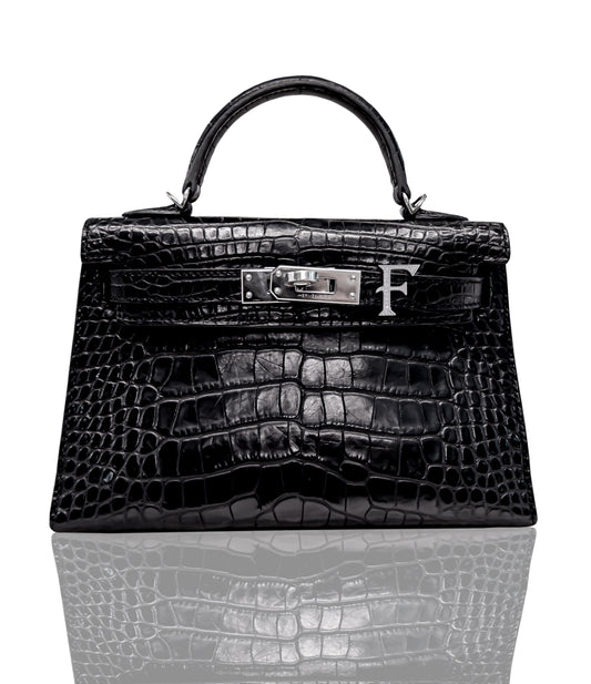 A black crocodile pattern handbag with a metallic clasp and a letter 'F' detail, collection-preview.