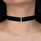 Black choker necklace with a small diamond pendant on a person's neck.