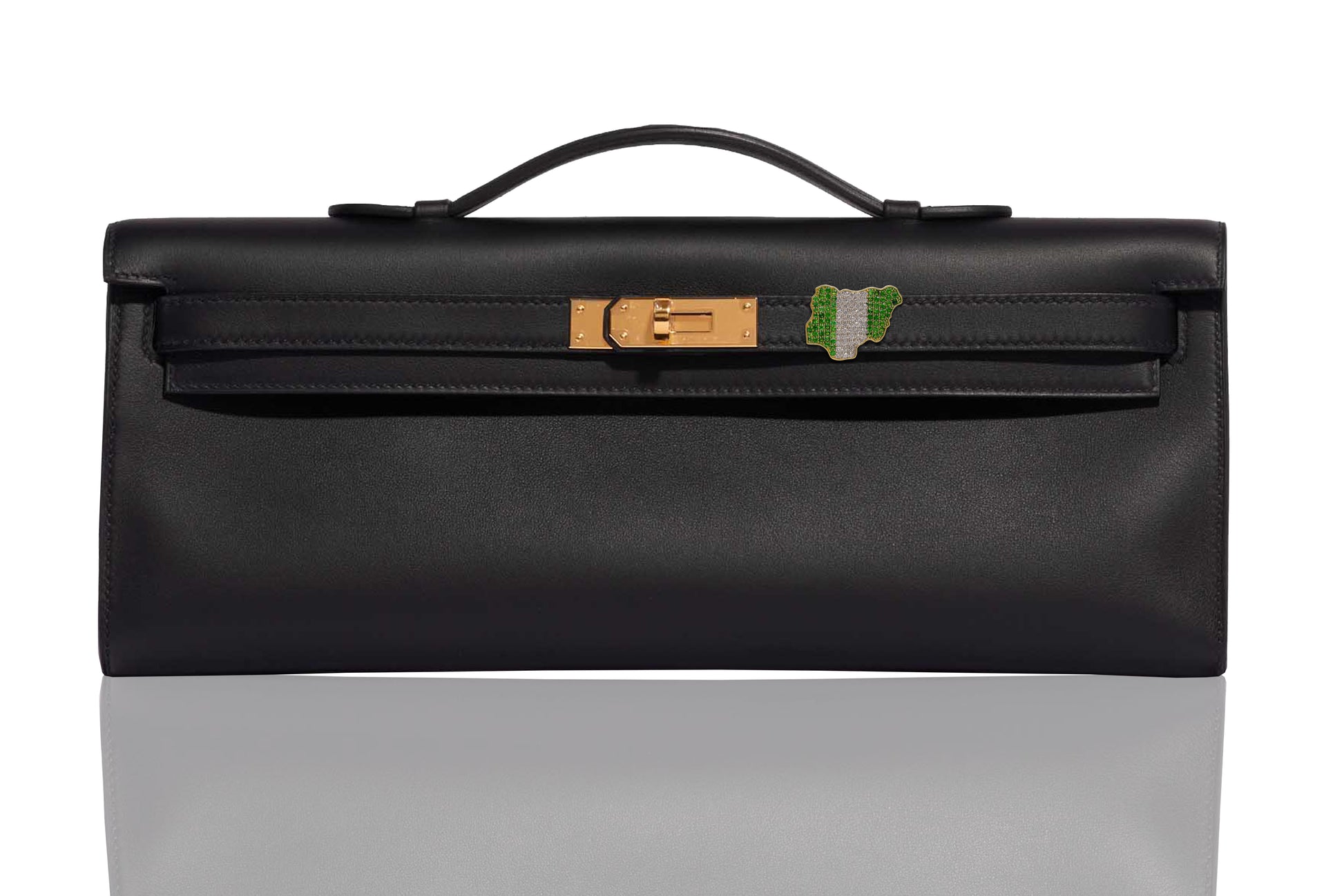 A black handbag with gold hardware, featuring a diamond and emerald embellishment on the front, collection-preview.