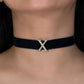 Black choker with a gold 'X' on a person's neck