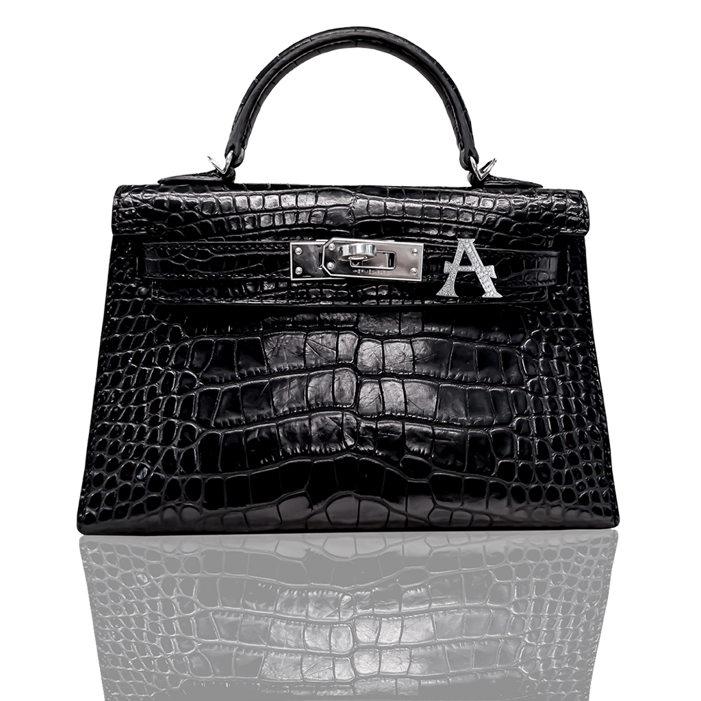 Black crocodile skin handbag with a visible brand logo on a white background, collection-preview.