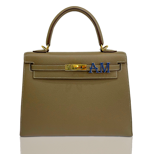 Brown handbag with gold hardware and blue letters on a white background, collection-preview