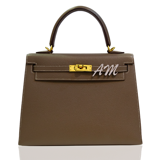 Brown handbag with gold hardware and 'AM' logo on a white background, collection-preview