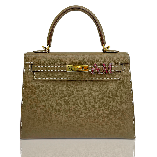 Beige handbag with gold hardware and a visible brand logo on a white background, collection-preview
