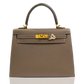 Brown handbag with gold hardware on a white background, collection-preview