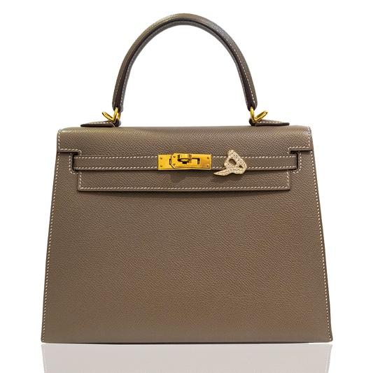 Brown handbag with gold hardware on a white background, collection-preview
