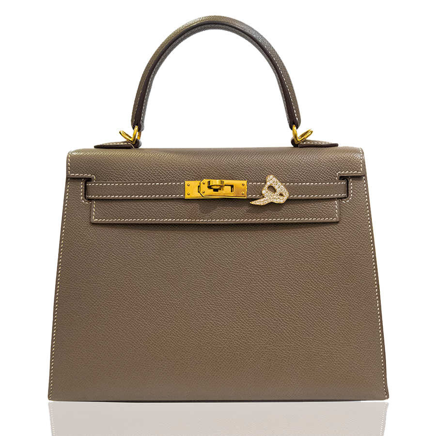 Brown handbag with gold hardware on a white background, collection-preview